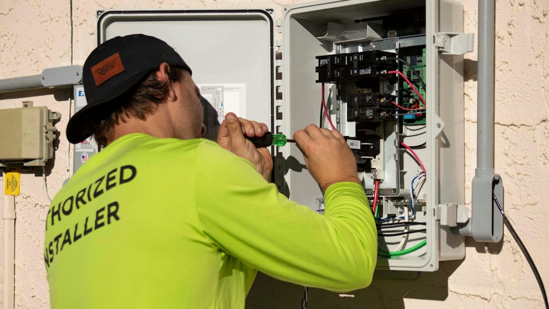 Technician working on an electrical panel